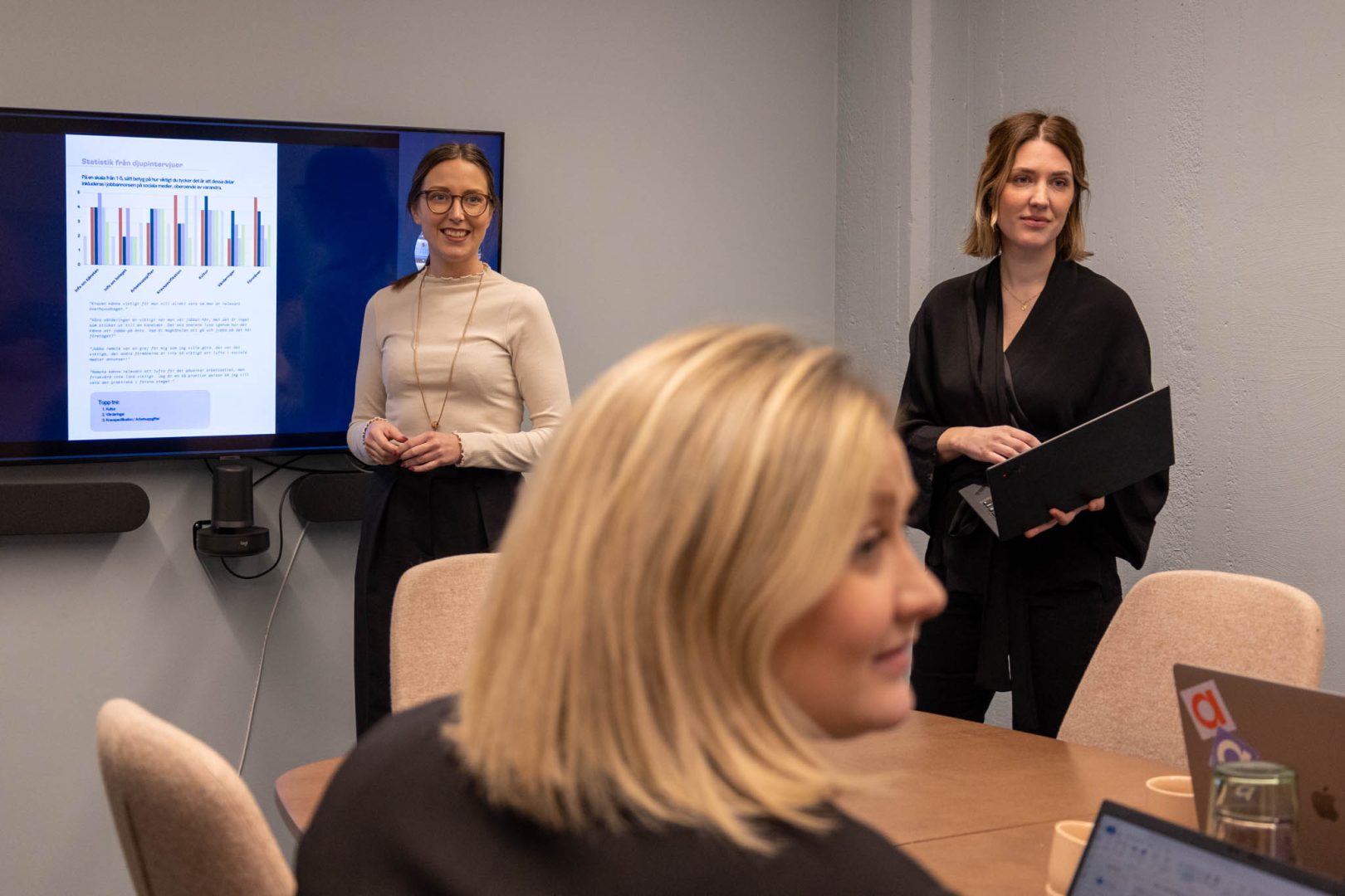 Två personer står vid en skärm och pratar om rollen som Head of Marketing Automation.